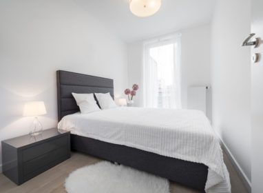 Stylish white bedroom in small room